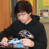 Senior Justin Du fixes a computer as part of his responsibilities as an in-school technology intern.