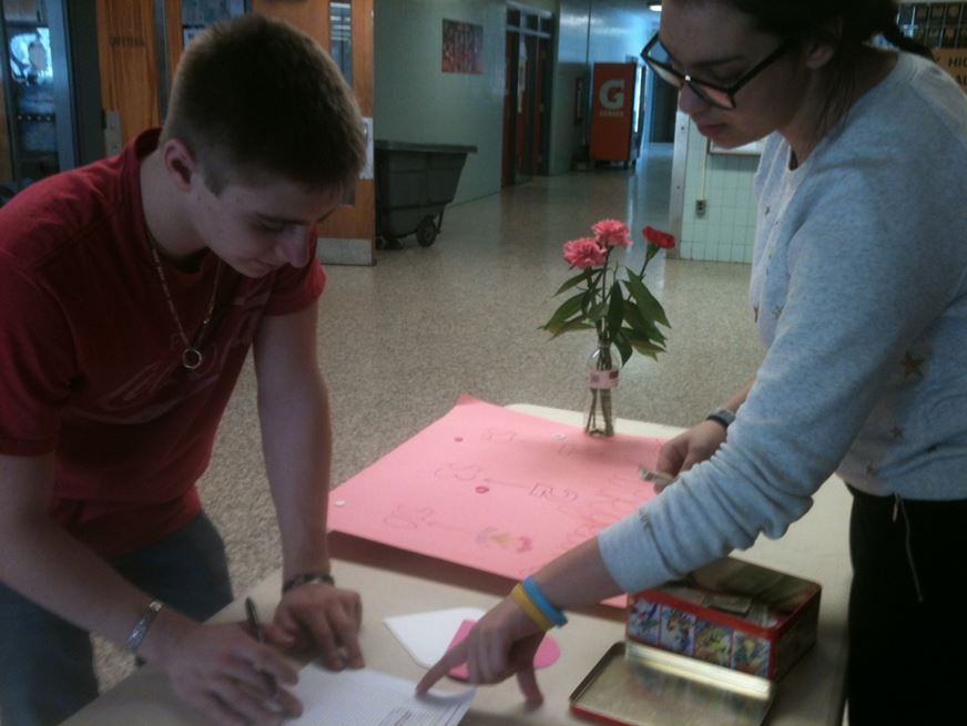 Junior Tyler Blanton buys multiple flower grams from junior Jude Ali, a French Club officer. The French Club said flowers will be delivered to homerooms on Valentine’s Day, Feb. 14. The snow date will be Tuesday, Feb 18. 