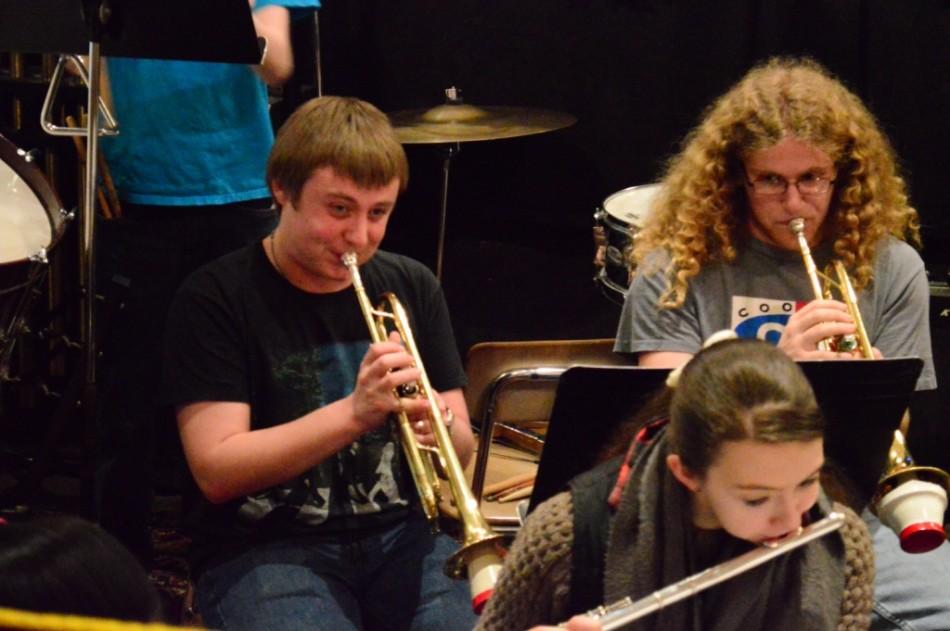 MUSICAL PRACTICE. (left to right) Seniors Aaron Gladstone, Mackenzie Forbes and Mark Hubbert practice the Act 2 finale for the musical “Into the Woods” in the auditorium pit March 4.