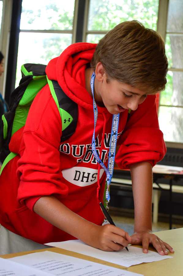 Freshman Nick Carter signs up for the Student Athletic Leadership Board at Club Rush on Sept. 15. Club Rush gives freshmen the opportunity to explore what the school has to offer while displaying 29 of the schools clubs.