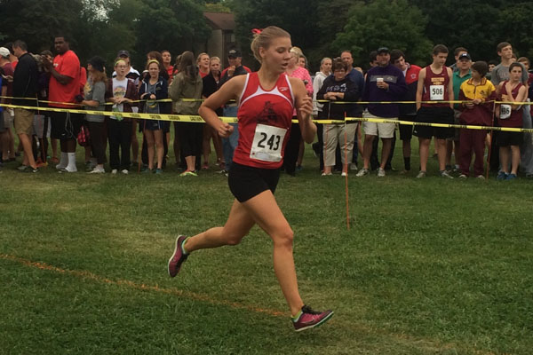 Junior Kristin Meek approaches the finish line at the Barnhart Invitational 5K on Sept. 13. Meek finished fourth in the girls varsity race with a time of 19:25.