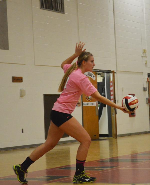 Junior Olivia Finkel prepares to serve during the Lions think pink game against Chesapeake Oct. 14. The Lions won 3-0 to continue their undefeated season as of Oct. 21. 