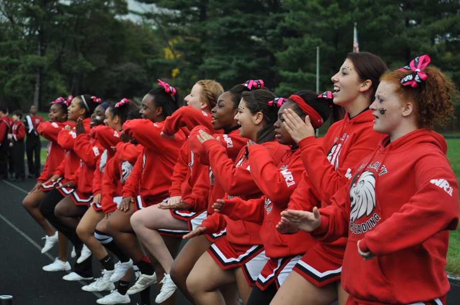 Varsity cheerleaders perform their spirit cheer during the first half of the Oct. 11 homecoming game. The varsity football team earned their fourth consecutive win, defeating Loch Raven 48-0. 