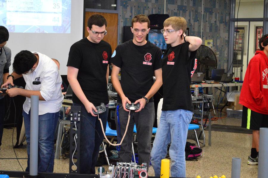 Left to right: Seniors Matthew Carbaugh, Sandor Tapolyai and Brian Levis prepare to send their robot through a series of programming tests Nov. 8. 
