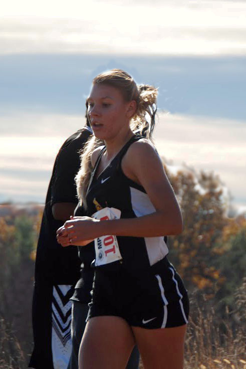 Junior Kristin Meek runs in the womens cross country championship Nov. 8. The team finished fourth overall