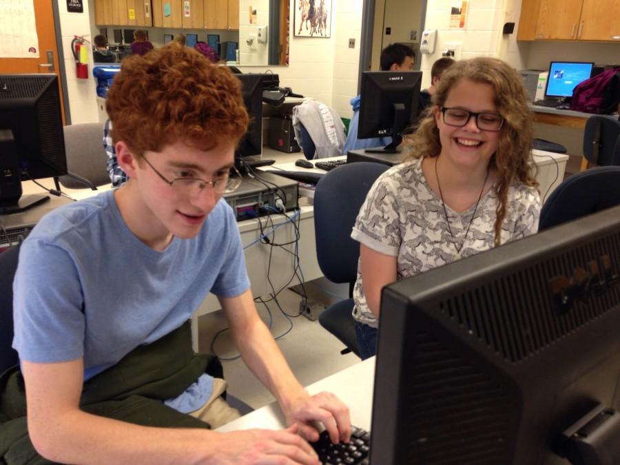 Left to right: Junior Jonah Langlieb teaches junior Cait Battle-
McDonald how to code at a club meeting last month.