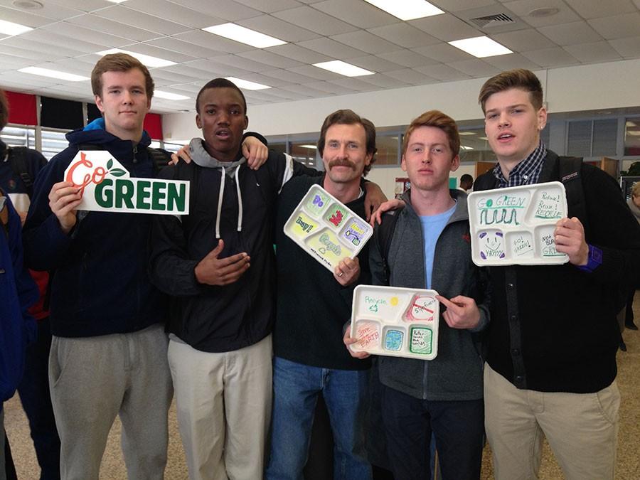 Junior Joey ODwyer, senior Sammy Ondieki, environmental science teacher John Enders, senior Colin Miller, and junior Tommy Parker celebrate the decision to stop using styrofoam trays to serve lunches. Beginning tomorrow, Feb. 20, the cafeteria will begin using recyclable trays.
