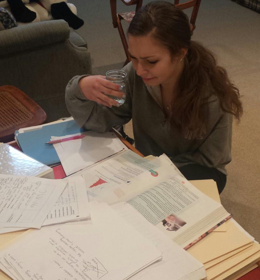 Senior Nicole Miller keeps her tear jar close as she slaves over her Advancement Placement economics notes and AP statistics homework. Miller contributed a total of 10 gallons of tears to the 2014 Pool Project. 