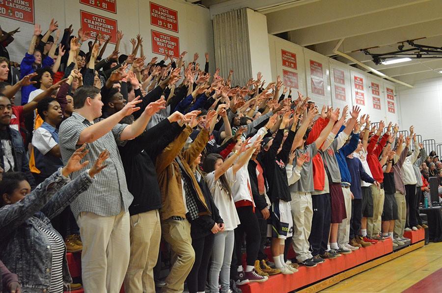 The Dulaney Student section holds up the traditional  “spirit fingers” during a Dulaney free throw in the 4th quarter of the boys varsity basketball game. Dulaney trumped Catonsville 63-62 in overtime. 