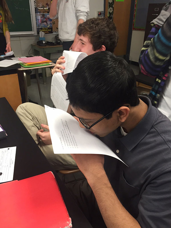 Seniors Bennett Heitt and Maroof Neebir complete a lab in forensic science by pressing their lips against a sheet of paper. They then used their prints to analyze different lip structures.