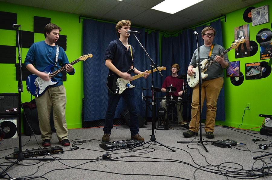Left to right: Juniors Andrew Rothchild, Peter Demesthias, Brady Sack and Tony Sheaffer rehearse a set of songs in the basement of Music Go Round, a Cockeysville music store.