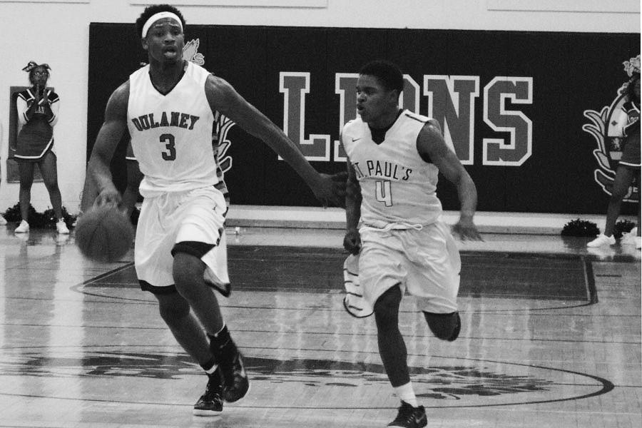 small forward Isaiah Lamb maneuvers past the St. Paul’s School for Boys defense in a home game Dec. 5.
