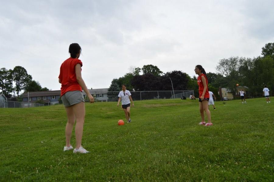 (Left to right) Juniors Michelle Wu, Sally Kim and Sumin Woo pass the ball to practice for an upcoming match.