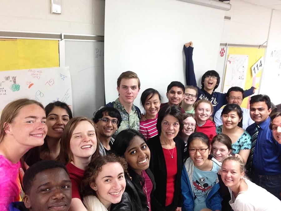 Skelton poses in a selfie with present and past students on the morning of her final day. 