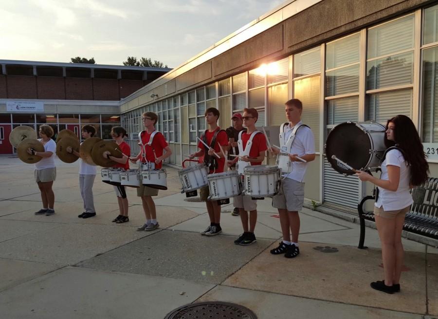 (Left to rightt) Seniors Isabell Muller, Gustavo Encarnacion, Sara Glasser and Brady Sack, juniors Sean Herrin and Alex Stocksdale, senior Jonathan Lindell and freshmen Alex Johnson were among the members of the Lions Roar Marching Band Drumline performing in front of the school to welcome students Aug. 24.