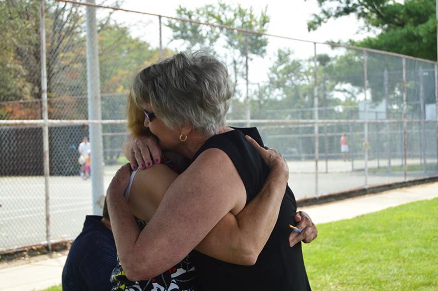 Gill embraces her sister, class of 69 alumna Carolyn Insley, moments after receiving the ring. 
