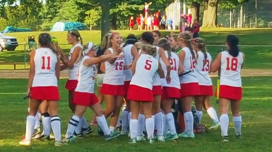 The girls varsity field hockey team celebrates their victory over Hereford High School after an overtime goal from junior Emma Klein Sept. 24

