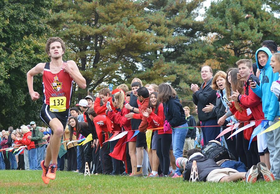 Walz approaches the finish line with a time of 15:43.61. Walz, who won the championship, was nearly beat by teammate, senior Elijah Hawkins, who followed closely behind with a 2nd place time of 15:48.26