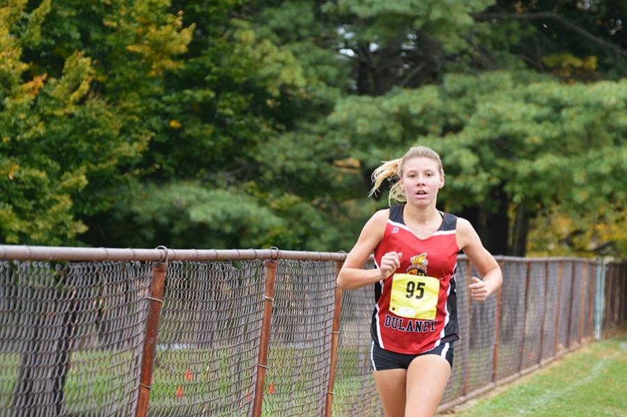 Senior Kristin Meek races along the gate during the fist part of the varsity girls championship. With a time of 18:43.24, Meek placed in 4th. 