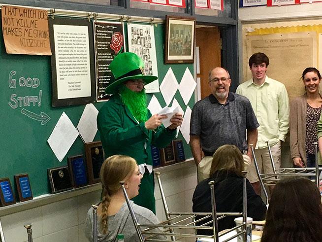 Advanced Placement United States history teacher John Wagner laughs as one of his five personalized limericks is read to him by Bowman. Wagner’s limericks contained references to history jokes he makes in his class.