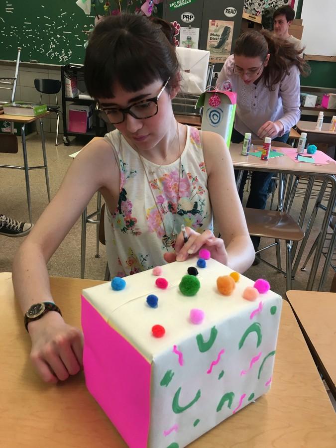Senior and Sequel Art Editor Jackie Andrews decorates a box for a totem decoration for Art Fest March 7. Art Fest is slated for April 14 after school in the auditorium lobby. 
