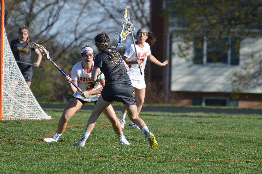Junior defender Kaitlyn Dabkowski (3) covers senior Catonsville attacker Andrea McTaggart (19) as she attempts to pass to a teammate behind the net. 