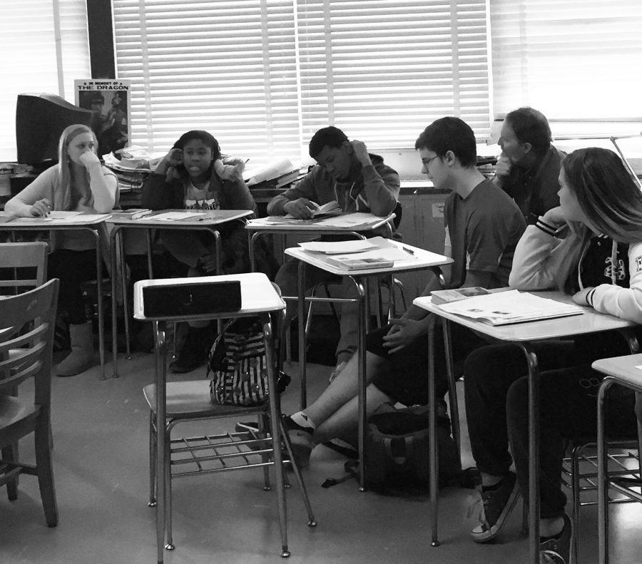 Freshmen  Kenyetta Bowman, Baasil Okollie, Dennis Mason and Courtney Garrison discuss race and its prevalence in the novel ‘To Kill a Mockingbird’ as English teacher Dirk Frey listens during Frey’s 2A Honors English 9 class.