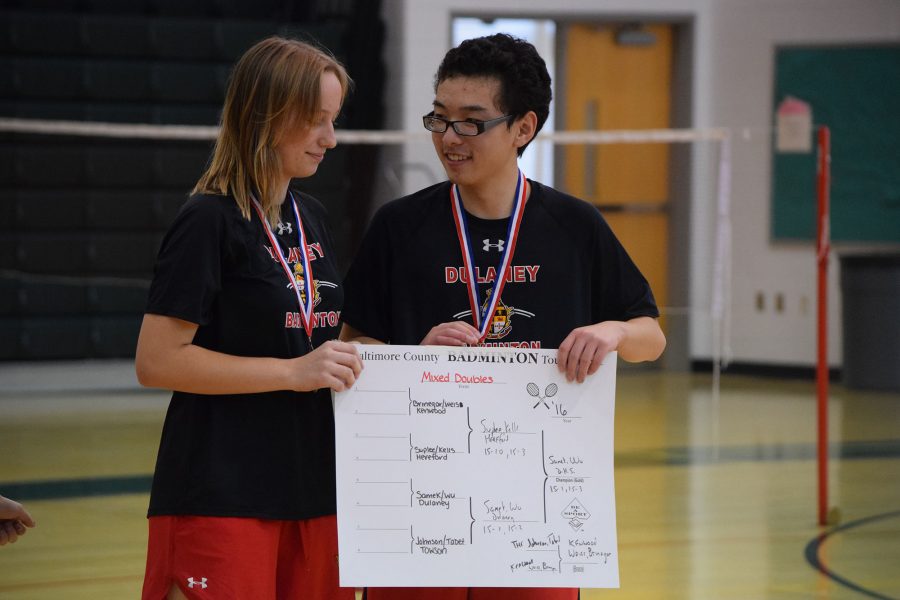 (From left to right) Freshman Nicolette Samek and senior Ari Wu pose with the Mixed Double scoreboard after winning gold in the tournament Oct. 29 at George Washington Carver Center for Arts and Technology. 