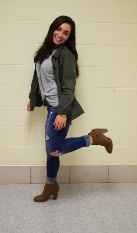 Senior Arianna Minas  sports a green cargo jacket from Nordstrom and a twist-up shirt with a layered necklace, both from Francesca’s, ripped jeans from American Eagle and booties from DSW Dec. 7.