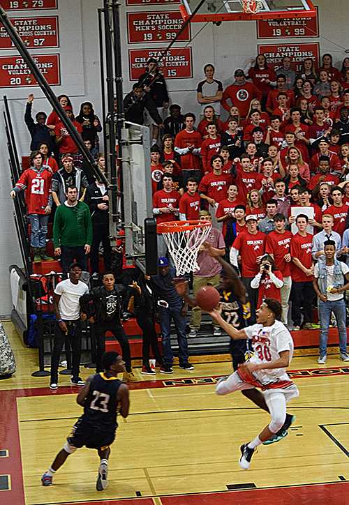 Junior Charlie Byers shoots a layup on a fast break during the Dec. 9 home game against Catonsville. Byers noted that the crowd pushes  him towards success during a game. “The fans are one of the best in the county and show so much support in all aspects of the game,” Byers said.
