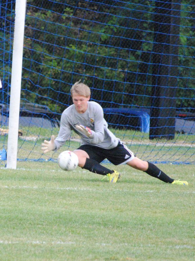 Senior Tyler Brown dives for a save during a 2015 varsity boys soccer game. Brown has suffered seven concussions and has had to stop playing soccer as a result.