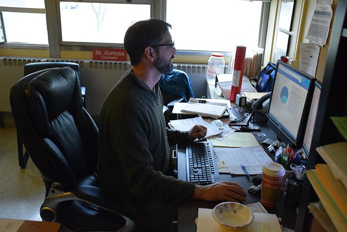 Guidance department chairman John Komosa works at his desk Dec. 12. We in the counseling office as well as teachers in the classrooms do reach out and encourage students to explore their potential, Komosa said.