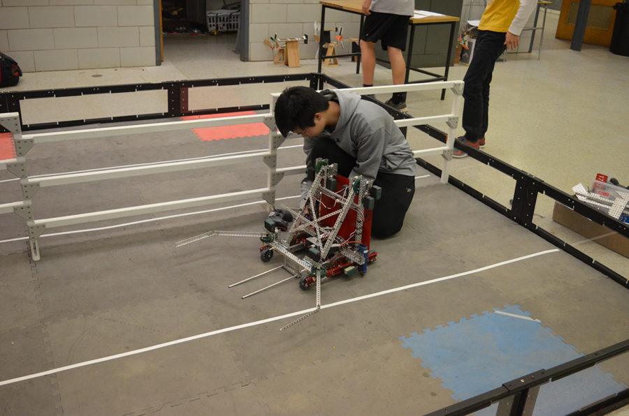 Junior Raymond Zou tests his robot during routine practice at the Robotics Club meeting in room 236 Feb. 28 in preparation for the state competition March 3 and March 4. His was one of six of the school’s teams competing in the event, which included 60 teams total.     He and the other members of VEX robotics team 1727G—junior Josh Lim, sophomore Beulah Lee and freshmen Samuel Wu, Ben Yin and Cindy Jia will compete in the VEX Worlds 2017 competition April 19 through 22 in Louisville, Ky. In the meantime, the team is working on redesigning their robot and building game strategy, Zou said.      “There is a lot of game strategy involved in Robotics. You can have a well-built robot, but without game strategy, you won’t win. If you have a mediocre robot, but good strategy, you have a stronger chance to win,” said Zou.