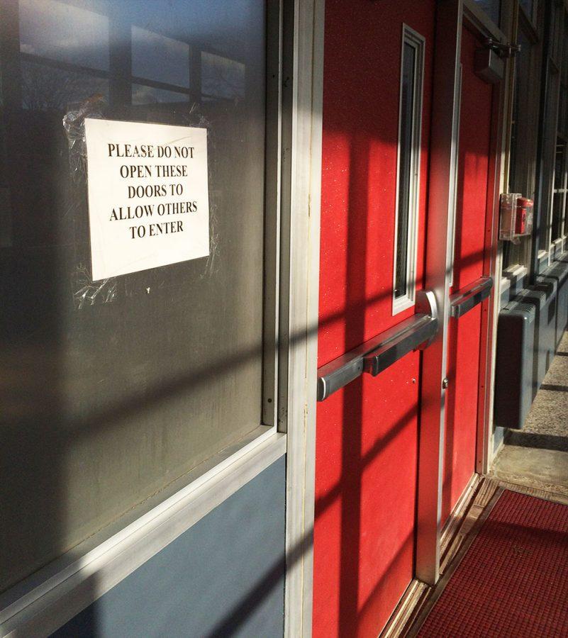 The sign on the doors in the main office hallway aims to deter students from letting others inside the building. Students are still being let in by teachers and their peers, an anonymous source reported.