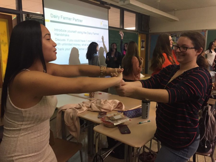  Juniors Toni Jade Coronel (left) and Carla Ireland (right) practice their “farmer’s handshake” as a team bonding exercise.